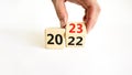 2023 happy new year symbol. Businessman turns a cube, symbolize the change from 2022 to the new year 2023. Beautiful white Royalty Free Stock Photo