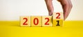 2022 happy new year symbol. Businessman turns a cube, symbolize the change from 2021 to the new year 2022. Beautiful yellow and Royalty Free Stock Photo