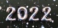 Happy New 2022 Year. 2022 tarnishing foil balloons and falling confetti on black background. Tarnish helium balloon numbers. Royalty Free Stock Photo