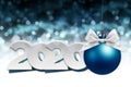 2020 Happy New Year text with blue christmas ball and silver ribbon bow isolated on blurred lights  Background for Flyers and Royalty Free Stock Photo