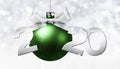 2020 Happy New Year text with green christmas ball and silver ribbon bow isolated on blurred lights  Background for Flyers and Royalty Free Stock Photo