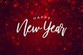 Happy New Year Text Over Red Sparkle Glitter Background. Magical Holiday Calligraphy Font with Glowing Defocused Bokeh Lights Back Royalty Free Stock Photo