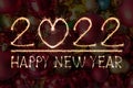 Happy New Year 2022 text hand written sparkles fireworks with Colorful fireworks of various colors at night Royalty Free Stock Photo