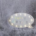 Happy New Year text in lightbox on grey minimalistic background Royalty Free Stock Photo