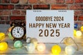 Happy New Year 2025 text message with alarm clock and LED cotton balls decoration Royalty Free Stock Photo