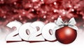 2020 Happy New Year text with red christmas ball and silver ribbon bow isolated on blurred lights  Background for Flyers and Royalty Free Stock Photo