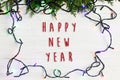 Happy new year text sign on christmas frame of garland lights on Royalty Free Stock Photo