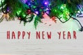 Happy new year text sign on christmas frame of garland lights on Royalty Free Stock Photo