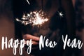 Happy new year text sign, greeting card.hand holding a burning f Royalty Free Stock Photo