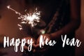 Happy new year text sign, greeting card.hand holding a burning s Royalty Free Stock Photo