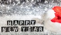 Happy new year text on snow, abstract bokeh lights background Royalty Free Stock Photo