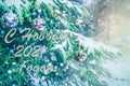 `Happy New Year 2021` text written by Cyrillic in Russian. Beautiful Christmas tree with snowflakes decorated with bright silver b Royalty Free Stock Photo