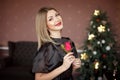 Happy New Year to you.One beautiful young woman in a black dress and bright makeup celebrating Christmas on the Royalty Free Stock Photo