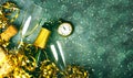 Happy New Year. Top view of champagne bottle,two glasses,golden streamers,antique clock and christmas lights with space for text. Royalty Free Stock Photo