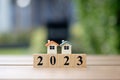 Happy new year 2023. Two house model on 2023 wooden blocks number. New year, New home. Royalty Free Stock Photo