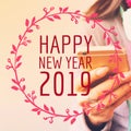 Happy New Year 2019 typography on image of woman using mobile ph