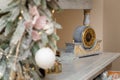 Happy New Year, vintage clock with golden dial, minutes past midnight. Winter holidays decorative elements. Blurry fir with