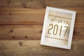 Happy new year 2017 on white vintage wooden frame on wood background Royalty Free Stock Photo