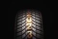 Happy new year 2023 and winter Car tire for snow isolated on black background. New automobile tyre for snowy road Royalty Free Stock Photo