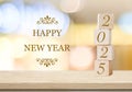 Happy New Year 2025 on wood cube block and blur white abstract bokeh light background, Happy new year 2025 greeting card, banner