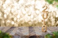 Happy new year 2018 on wood table and blur Christmas tree foreground at blur sparkling gold bokeh light wall,panoramic banner for Royalty Free Stock Photo