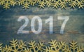 Happy New Year 2017 on a wooden background. Number 2017 on vintage style