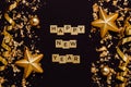 Happy New Year wooden golden letters, glitter with christmas toys and ribbons