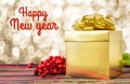 Happy new year word with Gold present box and ribbon on table wi