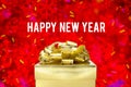 Happy new year word with Golden gift box with ribbon and colorful confetti at blur red snowflake boekh light background,Winter ho