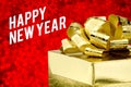 Happy new year word with Golden gift box with ribbon and colorful confetti at blur red snowflake boekh light background,Winter ho