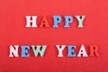 HAPPY NEW YEAR word on red background composed from colorful abc alphabet block letters. Royalty Free Stock Photo