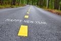 Happy new year words on asphalt road