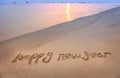 Happy new year written in beach Royalty Free Stock Photo