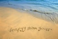 Happy new year written in beach Royalty Free Stock Photo