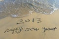 Happy new year written in beach Royalty Free Stock Photo