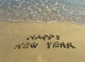 Happy new year written in beach Royalty Free Stock Photo