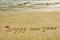Happy new year written in beach Royalty Free Stock Photo