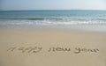 Happy new year written in beach Royalty Free Stock Photo