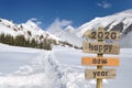 2020 happy new year written on a postsign in the snow Royalty Free Stock Photo