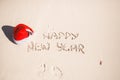 Happy New Year written in the sand and Santa Hat Royalty Free Stock Photo