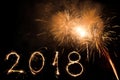 Happy new year 2018 written with sparkle firework and colorful fireworks as a background Royalty Free Stock Photo