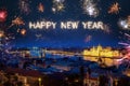 Happy New Year written with sparkle fireworks on night sky above Budapest surrounded by lots of fireworks Royalty Free Stock Photo