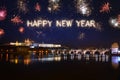 Happy New Year written with sparkle fireworks on night sky above Prague