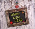 Happy new year written on Vintage sign board