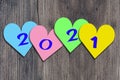 Happy New Year 2021. New year, new you, start, goals. Conceptual motivational message written with blue numbers on colorful harts.