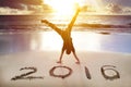 Happy new year 2016. young man handstand on the beach Royalty Free Stock Photo