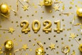 Happy New Years 2021. Christmas background with golden decorations, baubles, confetti.