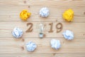 2019 Happy New years with lightbulb with crumbled paper and wooden number on table. New Start, Idea, Creative, Innovation, Resolut