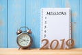 2019 Happy New years with Mission text on notebook, retro alarm clock and wooden number on table and copy space. Royalty Free Stock Photo