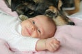 Happy Newborn Baby Snuggling with Pet Dog